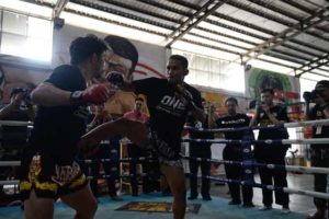 Thai mixed martial arts fighter Dejdamrong Sor Amnuaysirichoke (center) demonstrating his fighting skills at a ONE Championship promotion event in Bangkok.  AFP PHOTO 