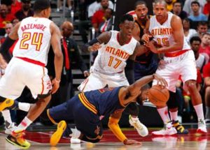 Kyrie Irving No.2 of the Cleveland Cavaliers slips as he drives against Dennis Schroder No.17 and Kent Bazemore No.24 of the Atlanta Hawks in Game Four of the Eastern Conference Semifinals during the 2016 NBA Playoffs at Philips Arena on Monday in Atlanta, Georgia. AFP PHOTO