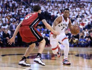 Kyle Lowry No.7 of the Toronto Raptors dribbles the ball as Tyler Johnson No.8 of the Miami Heat defends in Game Seven of the Eastern Conference quarterfinals during the 2016 NBA playoffs at the Air Canada Center on Monday in Toronto, Ontario, Canada. AFP PHOTO