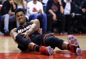 Hassan Whiteside No.21 of the Miami Heat injures his knee in the first half of Game 1 of the Eastern Conference Semifinals against the Toronto Raptors during the 2016 NBA Playoffs at the Air Canada Center on Wednesday in Toronto, Ontario, Canada. AFP PHOTO