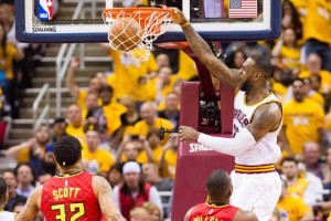 LeBron James No.23 of the Cleveland Cavaliers dunks over Mike Scott No.32 and Paul Millsap No.4 of the Atlanta Hawks during the second half of the NBA Eastern Conference semifinals at Quicken Loans Arena on Tuesday in Cleveland, Ohio.  AFP PHOTO