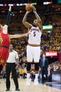 J.R. Smith No.5 of the Cleveland Cavaliers shoots a three point jump shot over Kyle Korver No.26 of the Atlanta Hawks during the first half of the NBA Eastern Conference semifinals at Quicken Loans Arena on Thursday in Cleveland, Ohio. AFP PHOTO 