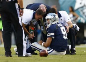 Dallas Cowboys quarterback Tony Romo is looked at by medical personal after getting injured during the game against the Philadelphia Eagles at Lincoln Financial Field on September 20, 2015. AFP PHOTO