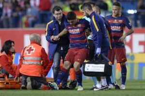 Barcelona’s Uruguayan forward Luis Suarez (center) is assited after being injured beside Barcelona’s Argentinian forward Lionel Messi during the Spanish “Copa del Rey” (King’s Cup) final match FC Barcelona vs Sevilla FC at the Vicente Calderon stadium in Madrid on May 22. AFP PHOTO