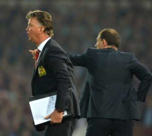 Manchester United’s Dutch manager Louis van Gaal (left) and West Ham United’s Croatian manager Slaven Bilic gesture during the English Premier League football match between West Ham United and Manchester United at The Boleyn Ground in Upton Park, in east London on May 10. AFP PHOTO