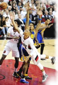 Damian Lillard (No. 0) of the Portland Trail Blazers drives to the basket on Brandon Rush (No. 4) of the Golden State Warriors in the third quarter of Game Three of the Western Conference Semifinals during the 2016 NBA Playoffs at the Moda Center in Portland, Oregon.  AFP PHOTO