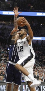 LaMarcus Aldridge (No. 12) of the San Antonio Spurs scores over Steven Adams of the Oklahoma City Thunder during game one of the Western Conference Semifinals for the 2016 NBA Playoffs at AT&T Center in San Antonio, Texas. AFP Photo