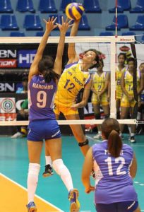 Air Force’s Joy Cases (No.12) soars for a kill against BaliPure’s Janine Marciano during their Shakey’s V-League showdown at The Arena. CONTRIBUTED PHOTO