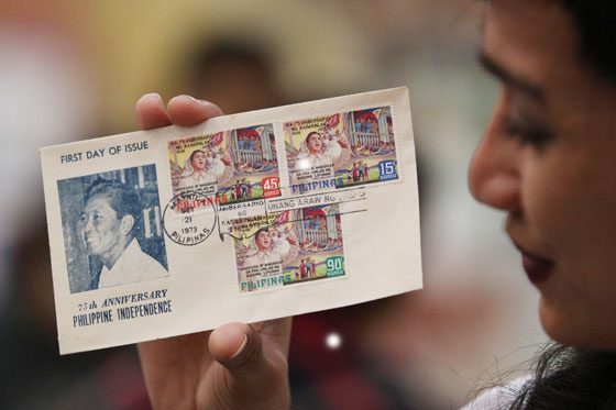 Brian San Miguel holds a 43-year-old First Day Cover bearing stamps issued to mark the observance of the country’s 75th Independence Day in 1973. The Philippine Postal Corp. launched a stamp exhibit Friday as part of the early celebration of the country’s 118th Independence Day. PHOTO BY RUSSELL PALMA 