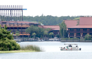 KILLER ALLIGATOR HUNT Orlando, Florida : A boat from the Orange County Sheriff’s office searches the Seven Seas lagoon ouside Disney’s Polynesian Village Resort near Orlando, where a two-year old boy was snatched  by an alligator. AFP PHOTO