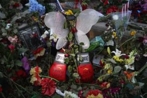 Momentos, including a pair of boxing gloves, lie at a makeshift memorial for Muhammad Ali outside the Muhammad Ali Center on Thursday in Louisville, Kentucky.  AFP PHOTO 