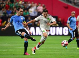 Diego Godin No.3 of Uruguay passes the ball in front of Hector Herrera No.16 of Mexico during the 2016 Copa America Centenario Group C match at University of Phoenix Stadium on Monday in Glendale, Arizona. AFP PHOTO