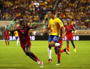 Philippe Coutinho No.22 of Brazil and Romain Genevois No.5 of Haiti fight for the ball during a Group B match of the 2016 Copa America Centenario at Camping World Stadium on Thursday in Orlando, Florida.  AFP PHOTO