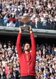 Serbia’s Novak Djokovic holds the trophy after winning the men’s final match against Britain’s Andy Murray at the Roland Garros 2016 French Tennis Open in Paris on Monday. AFP PHOTO