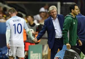 England’s forward Wayne Rooney shakes hands with England’s coach Roy Hodgson as he is substituted with England’s forward Marcus Rashford during Euro 2016 round of 16 football match between England and Iceland at the Allianz Riviera stadium in Nice on Tuesday. AFP PHOTO