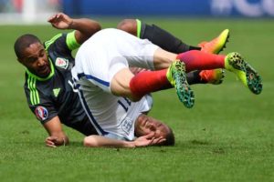 England’s forward Jamie Vardy (right) clashes with Wales’ defender Ashley Williams during the Euro 2016 group B football match between England and Wales at the Bollaert-Delelis stadium in Lens on Friday.   AFP PHOTO