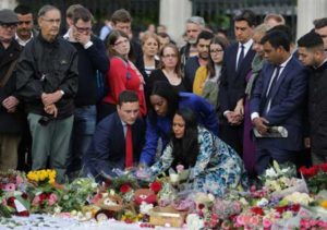 A NATION IN GRIEF Labor party MP and former Party leader Ed Miliband (5R) looks on as people lay a tribute during a vigil at the heap of flowers and candles in remembrance of slain Labor MP Jo Cox in Parliament Square in front of the Houses of Parliament in London on Friday (Saturday in Manila). AFP PHOTO