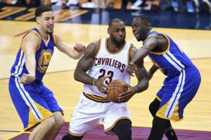 LeBron James No.23 of the Cleveland Cavaliers handles the ball against Klay Thompson No.11 of the Golden State Warriors and Draymond Green No.23 during the first half in Game 3of the 2016 NBA Finals at Quicken Loans Arena on Thursday in Cleveland, Ohio. AFP PHOTO