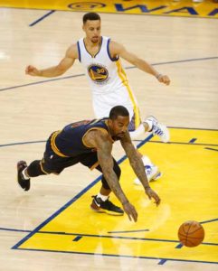Cleveland Cavaliers center Tristan Thompson (bottom) dives for a loose ball ahead of Golden State Warriors guard Stephen Curry during the first quarter of Game 1 of the NBA finals on Friday in Oakland, California. AFP PHOTO