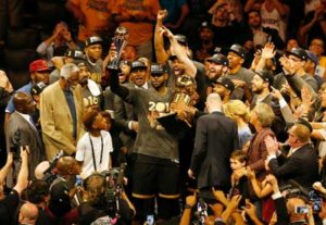 Cleveland Cavaliers forward LeBron James hoists the Larry O’Brien and the Finals MVP trophies after defeating the Golden State Warriors to win the NBA Finals on Monday in Oakland, California. AFP PHOTO