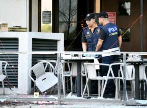 RIVALRY ANGLE SUSPECTED Malaysian forensic experts inspect the site of grenade attack at a restaurant in Puchong district outside of Kuala Lumpur on Tuesday. Eight people were injured. AFP PHOTO