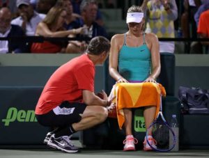 Maria Sharapova of Russia talks with her coach Sven Groeneveld during a match against Dania Gavrilova of Russia during Day 4 of the Miami Open presented by Itau at Crandon Park Tennis Center on March 26, 2015 in Key Biscayne, Florida.  AFP FILE PHOTO 