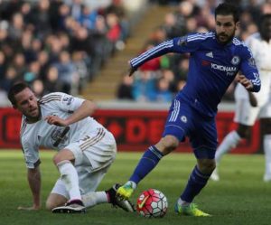 Swansea City’s Gylfi Sigurdsson (left) fights for the ball with Chelsea’s Cesc Fabregas during their English Premier League match, at The Liberty Stadium in Swansea, south Wales, on April 9.  AFP PHOTO