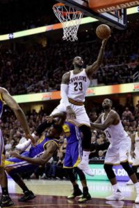 LeBron James #23 of the Cleveland Cavaliers drives to the basket against Festus Ezeli #31 of the Golden State Warriors in the second half in Game 6 of the 2016 NBA Finals. AFP PHOTO