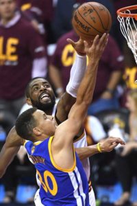 Stephen Curry (No. 30) of the Golden State Warriors takes a shot against Kyrie Irving of the Cleveland Cavaliers during 2016 NBA Finals at Quicken Loans Arena in Cleveland, Ohio.  AFP FILE PHOTO