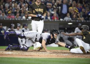 Melvin Upton Jr. (right) of the San Diego Padres steals home ahead of the tag of Nick Hundley (left) of the Colorado Rockies during the fourth inning of a baseball game at PETCO Park in San Diego, California.  AFP PHOTO