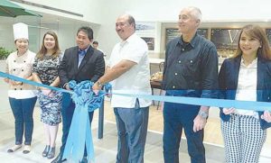  Volkswagen and Ilustrado executives pose for a photograph during the ribbon cutting ceremony of the V by Ilustrado Cafe and Lounge at the Volkswagen dealership in BGC, Taguig.  Photo shows Volkswagen Philippines president and CEO John Philip Orbeta (4th from left) and Ilustrado Group president and CEO Bonifacio Pimentel.