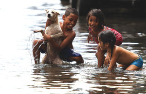 FUN IN THE RAIN Children play along the flooded streets of united nations avenue in manila, unaware of the water-borne diseases associated with the rainy season. PHOTO by RUSSELL PALMA 