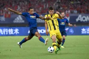 Manchester United’s Memphis Depay (left) fights for the ball with Dortmund’s Sokratis Papastathopoulos during the 2016 International Champions Cup football match between Manchester United and Dortmund in Shanghai on July 22. AFP PHOTO