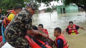 Nepalese army personnel rescue flood victims at Nawalparasi, some 200 kilometers southwest of Kathmandu, on July 26. At least 33 people have died in floods and landslides triggered by heavy rains in Nepal and dozens more are missing, a government official said. AFP PHOTO/NEPAL ARMY