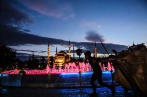 Taken on January 12, this file photo shows a man who collects paper dragging his cart past an illuminated fountain in front of the Blue Mosque, in Istanbul’s tourist hub of Sultanahmet. The tourists are so scarce nowadays you can hear their footsteps clattering down the empty shopping street. Nearly a week after the deadly airport bombings, it is eerily quiet in Istanbul. AFP PHOTO