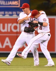 Mike Trout No.27 of the Los Angeles Angels and Kole Calhoun No.56 of the Los Angeles Angels celebrate as after defeating the Texas Rangers 9-5 at Angel Stadium of Anaheim on Tuesday in Anaheim, California. AFP PHOTO