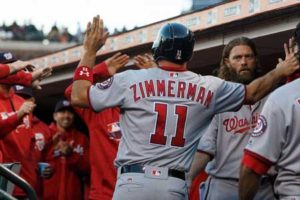 Ryan Zimmerman No.11 of the Washington Nationals is congratulated by teammates in the dugout after scoring a run against the San Francisco Giants during the second inning at AT&T Park on Friday in San Francisco, California. AFP PHOTO