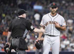 Madison Bumgarner No.40 of the San Francisco Giants talks with home plate umpire Mike Estabrook after a play during the fourth inning of a baseball game against the San Diego Padres at PETCO Park on Saturday in San Diego, California. AFP PHOTO