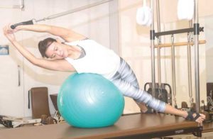 Roselle Monteverde demonstrates the use of a stability ball for the Side Bend, a routine that works on the lateral side and strengthens the oblique muscles for balance and strengthening Photos by NAZZI CASTRO