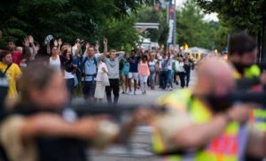 MALL TERROR Evacuated people from the shopping mall the Olympia Einkaufzentrum (OEZ) walk with their hands raised following a shooting on Saturday. AFP PHOTO