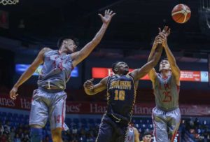 Abdulrazak Abdulwahab of Jose Rizal University battles for the ball against Aldrin Serafico (14) and Mark Malabanan (15) of Lyceum of the Philippines University.   PHOTO BY NAZZI CASTRO 