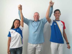 Sports patron James Lafferty, the force behind athletics’ Adopt-an-Olympian Program raises the arms of long jump queen Marestella Torres and pole vault sensation Ernest John “EJ” Obiena. Lafferty is helping Torres and Obiena, both national record holders and Southeast Asian Games gold medal bets, fulfill their dreams of securing berths at the 2016 Rio Olympics.  Contributed photo 