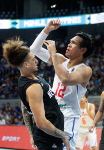 June Mar Fajardo (right) goes for a rebound against Isaac Fotu of New Zealand during the group stage of the FIBA Olympic Qualifying Tournament at the Mall of Asia Arena in Pasay City. CONTIRIBUTED PHOTO