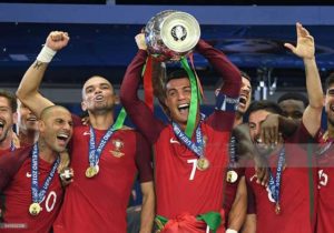 Cristiano Ronaldo of Portugal (center) lifts the European Championship trophy after his side win 1-0 against France during the UEFA EURO 2016 Final match between Portugal and France at Stade de France in Paris, France. AFP PHOTO