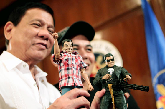 President Rodrigo Duterte poses with toy maker Dennis Mendoza while showing two custommade action figures of himself. One shows Duterte wearing a checkered polo shirt and jeans while the other shows him as ‘The Punisher,’ Duterte is known to have an iron-fist approach in addressing crime. MALACAÑANG PHOTO 