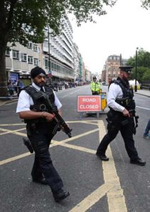 ARMED AND READY: Armed police personnel walk past a crime scene in London’s Russell Square on Thursday, following a knife attack in which one woman was killed and five others injured. A woman was killed and five people injured in a knife attack in central London on Wednesday which police said they are investigating for possible terrorist links. A 19-year-old man was arrested in Russell Square, in the city center, which was cordoned off after the attack as police swarmed the area. AFP PHOTO