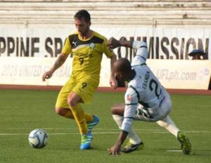 Ceres La Salle FC striker Adrian Gallardo Valdez (left) mounts a shot against Green Archers United FC’s William Ebanda during a first round game of the United Football League. PHOTO BY JAELLE NEVIN REYES