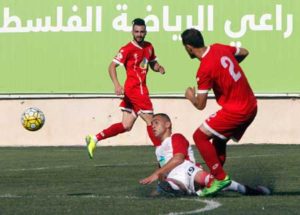 Mohammed Daoud Homaidan (right) of Hebron’s Ahly al-Khalil fights for the ball with Hazem Akram Shakshak (center) of Gaza’s Khan Yunis during the second leg of their Palestinian Cup final on Wednesday in the West Bank city of Hebron. AFP PHOTO