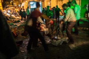 MERCILESS ATTACK People carry an injured man on the site of an explosion late on Saturday in Gaziantep following a late night militant attack on a wedding party in southeastern Turkey. AFP PHOTO