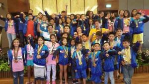 The Philippine Swimming League delegation with its President Susan Papa, Secretary General Maria Susan Benasa, coaches Alex Papa, Ryan Robles and Joey Andaya celebrates with all the Filipino medalists during the culmination of the 2016 Singapore Invitational Swimming Championship. CONTRIBUTED PHOTO